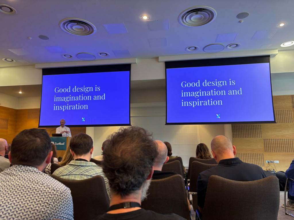Speaking at UX Scotland - the slides behind me say "Good design is imagination and inspiration."